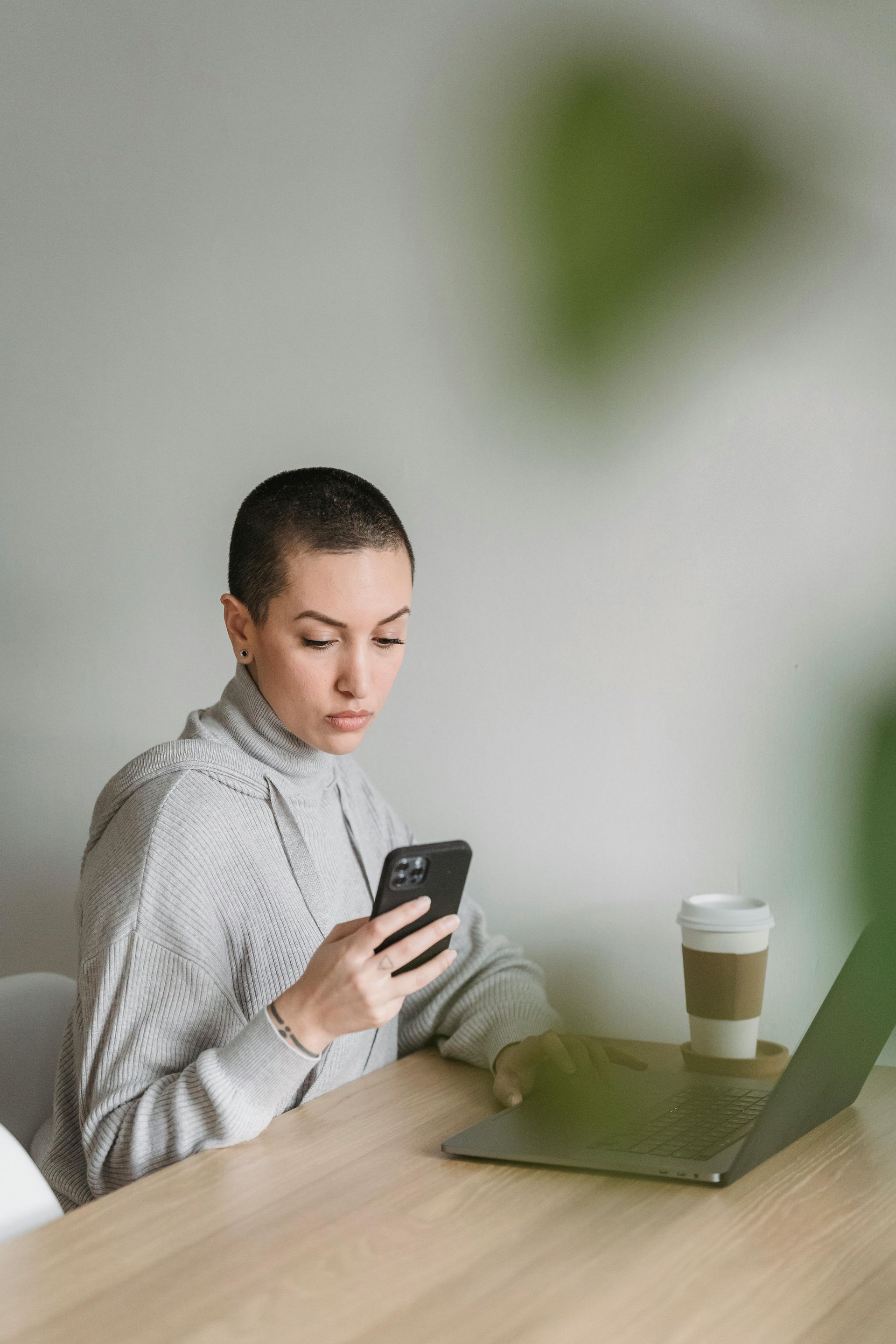 Therapist in a pink blouse meeting a client during an online therapy session